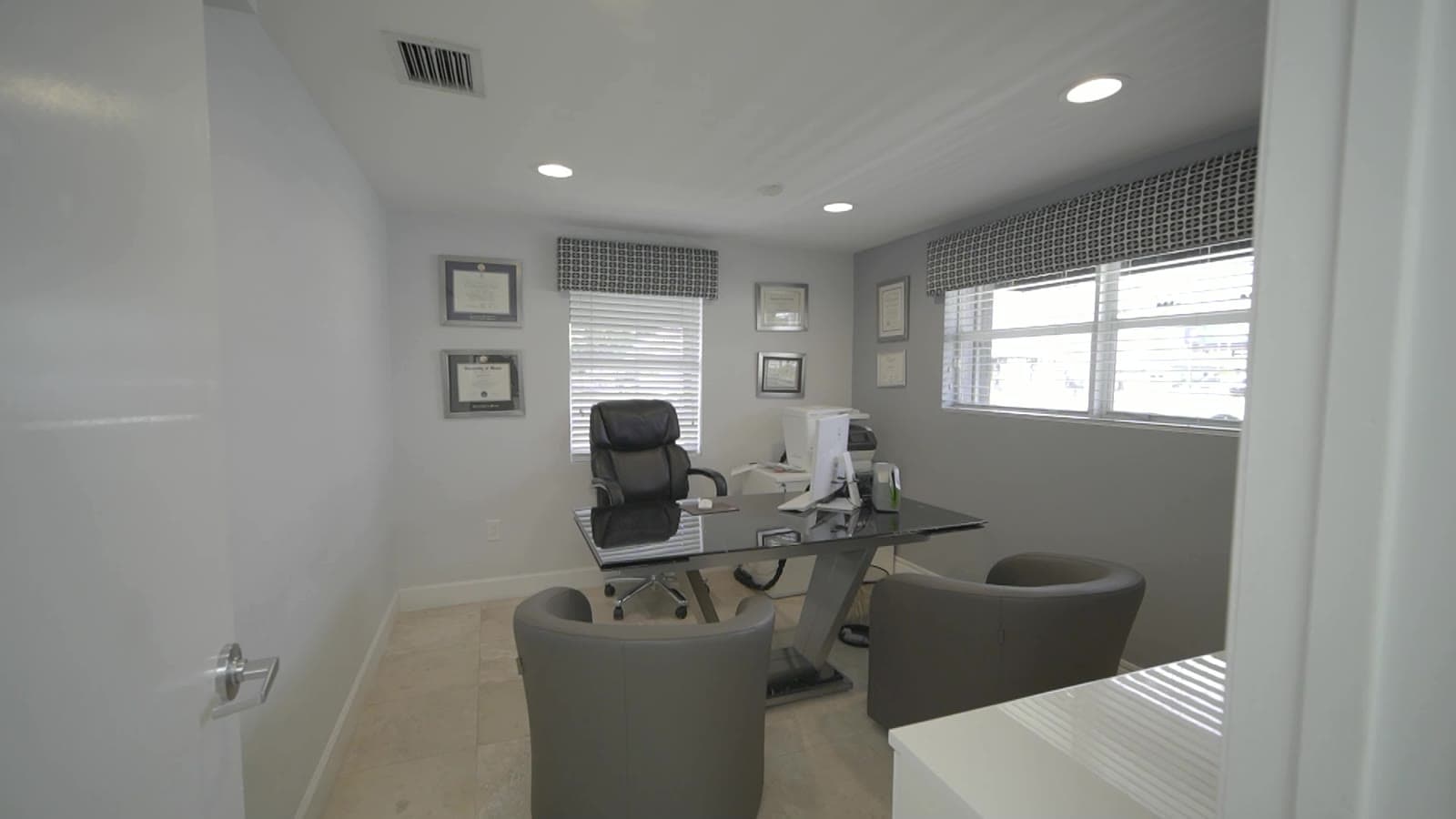 Consultation room with desk and chairs at our office